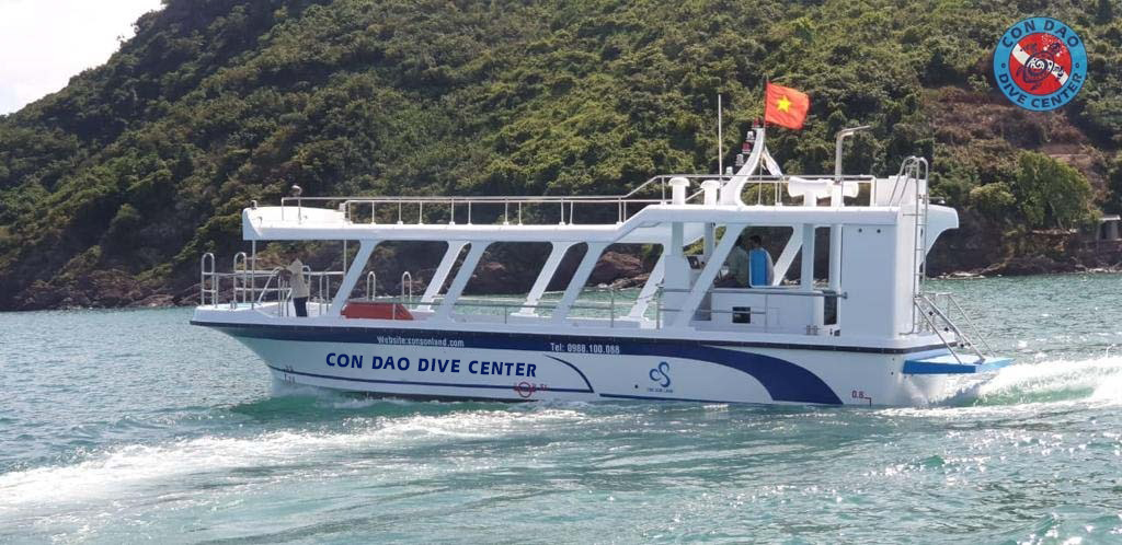 Private snorkeling experience boat by Con Dao Dive Center cruising in clear waters around Con Dao island Vietnam